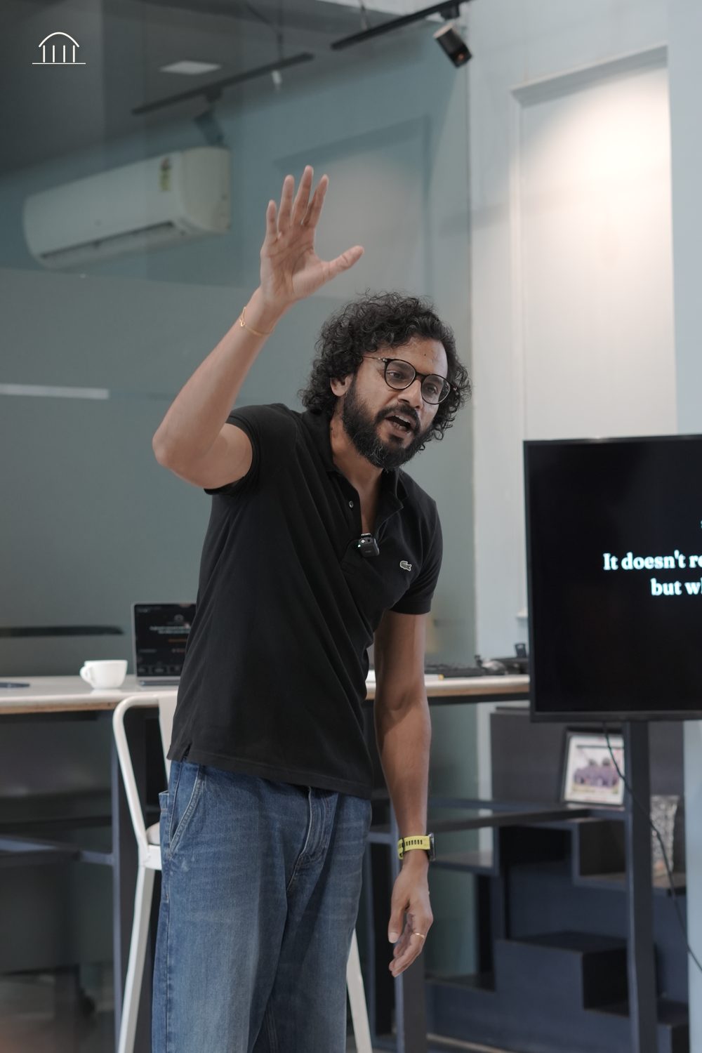 Rajat Asawa presenting, mid-gesture